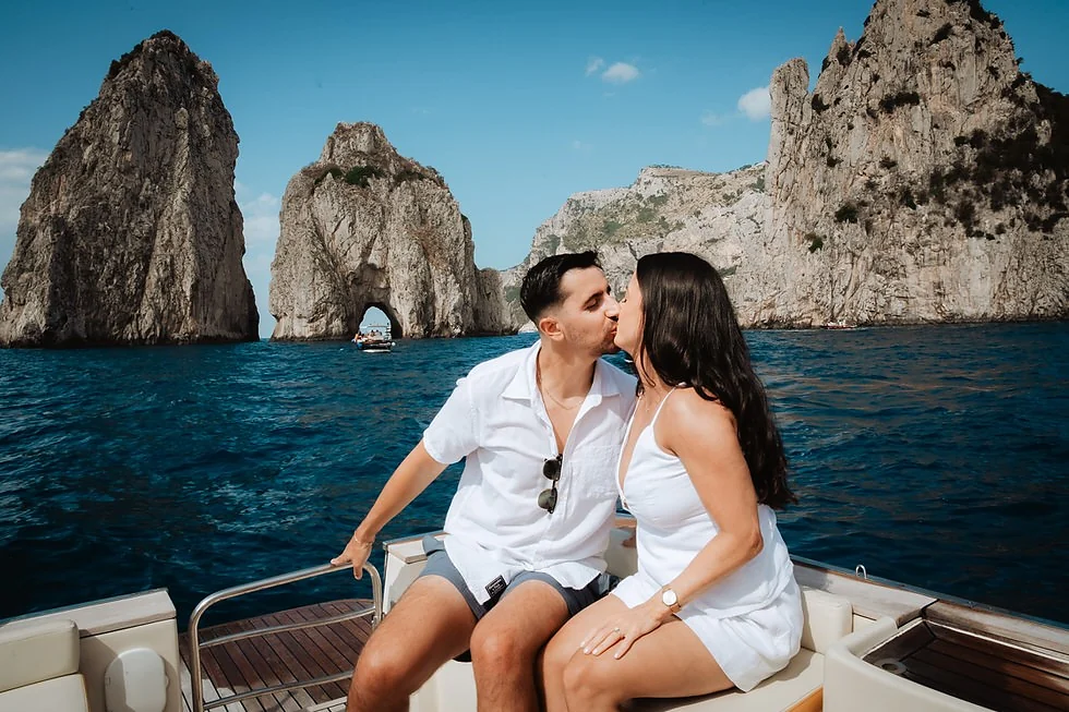 Couple sharing wine on deck at sunset